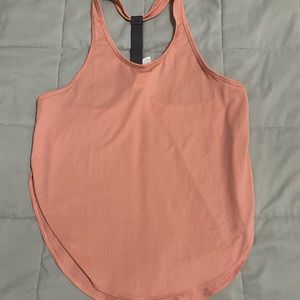 BNWOT Fabletics workout tank top. Light coral/Mauve color. High slits on sides.